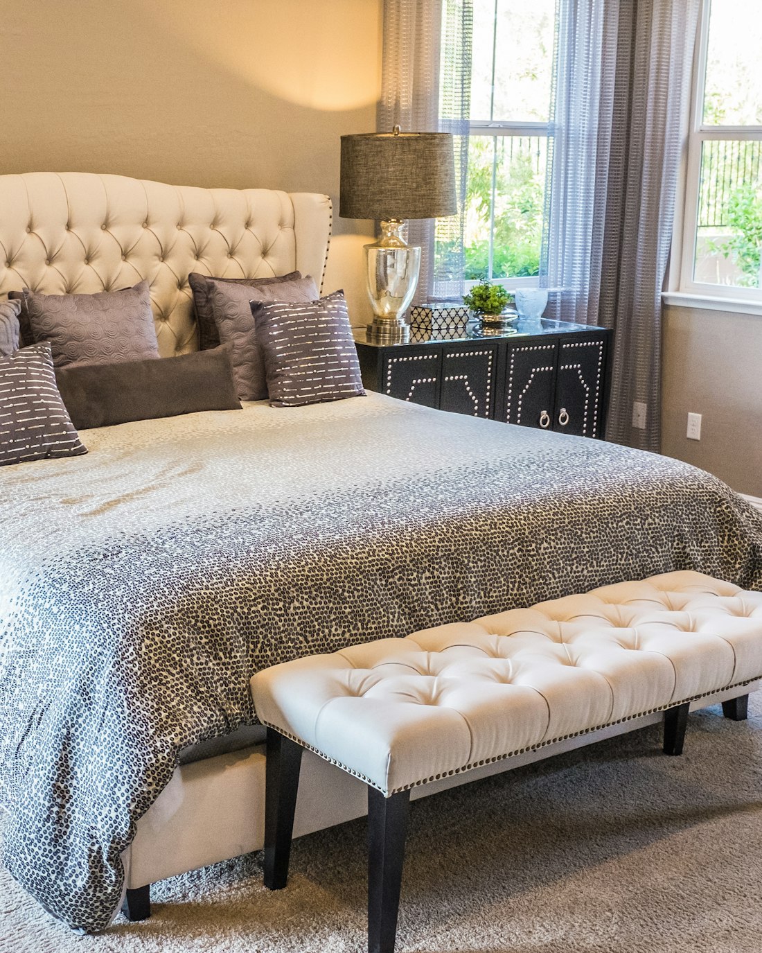 A softly lit bed with cosy bedding, set up for a restful night