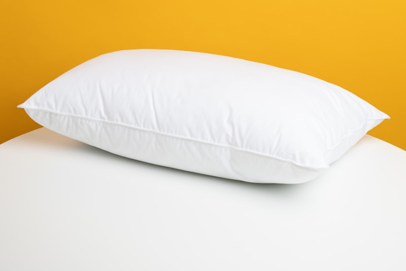 Stacked pillows on a made bed